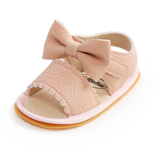 Sandales bébé en cuir rose avec un noeud papillon spéciale premier pas semelle antidérapante